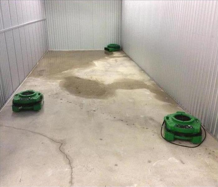Air movers drying up floor of a building